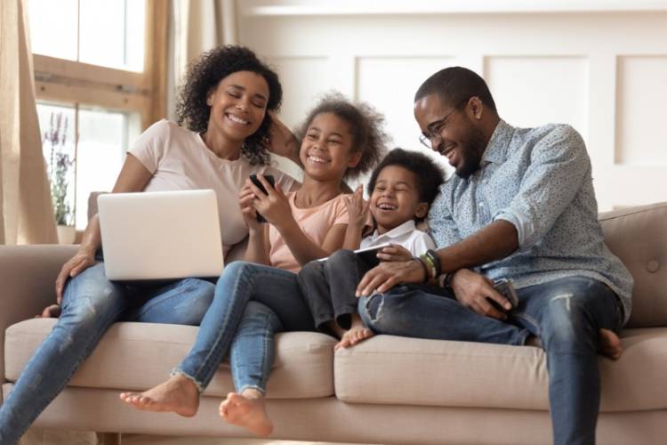 A young family joyfully creating their Disneyland itinerary. A young family joyfully creating their Disneyland itinerary.
