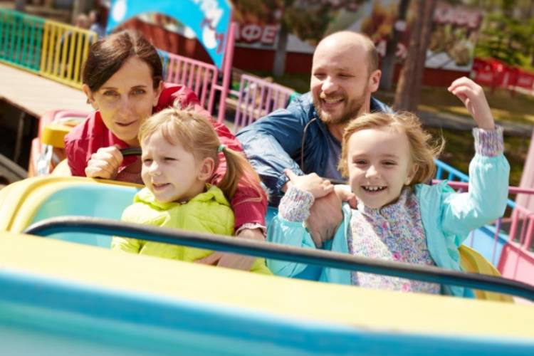 Disneyland Winter A young family gleefully enjoys a ride at Disneyland while on winter vacation in Southern California.